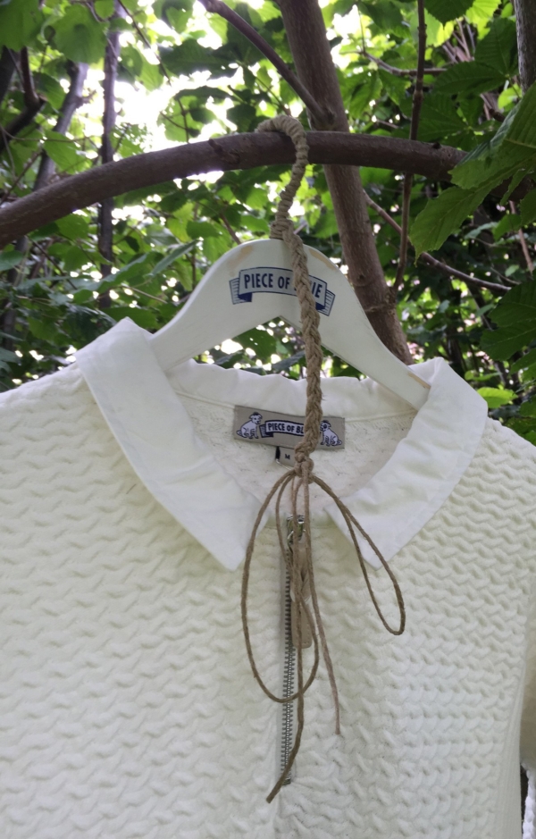 Close up. Basic and Elegant Pullover in White. Piece of Blue.