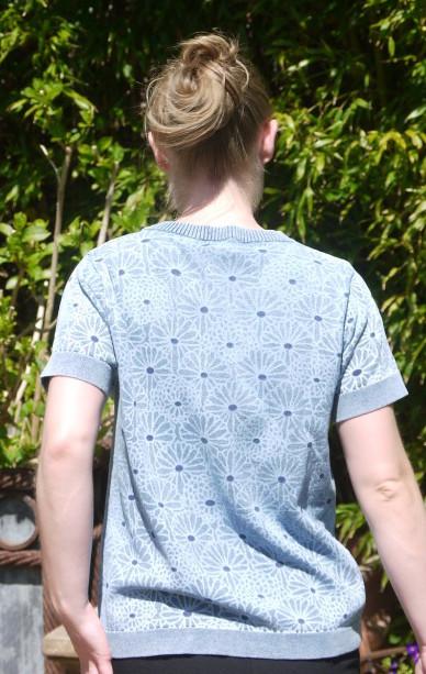 Feminine short Sleeved Pullover in light Indigo Blue with flower Print from Piece of Blue on model from behind