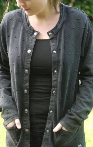 Black Grey Cardigan with Knitted Dot Pattern for Women from Piece of Blue. On model 1.